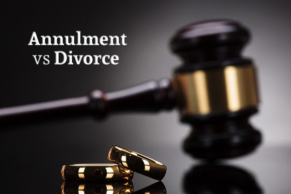 Two wedding rings with a gavel in the background below the words "Annulment vs Divorce"