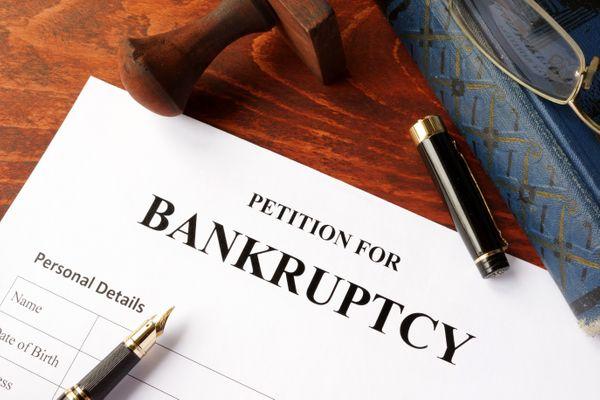 A form for bankruptcy with a book and gavel near it.