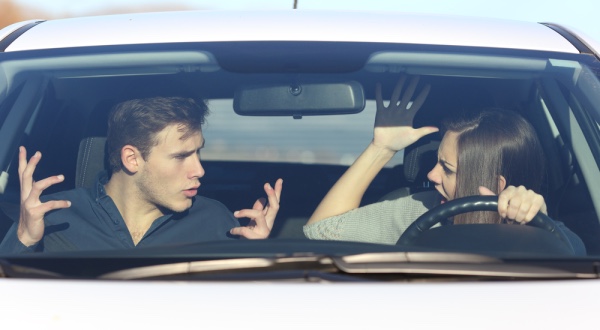 A couple arguing in a car.