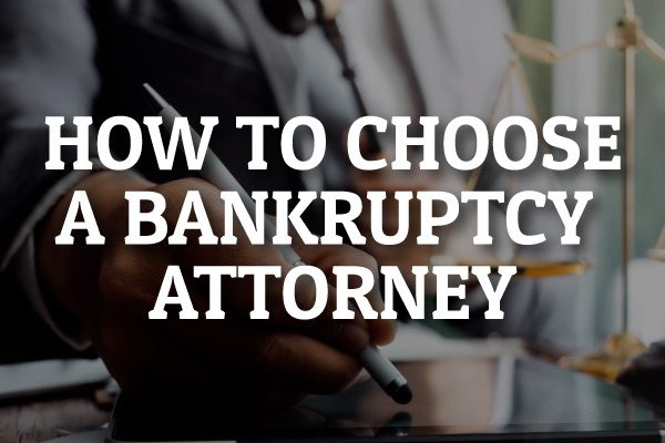 An attorney talking with a client with the words, "how to choose a bankruptcy attorney."