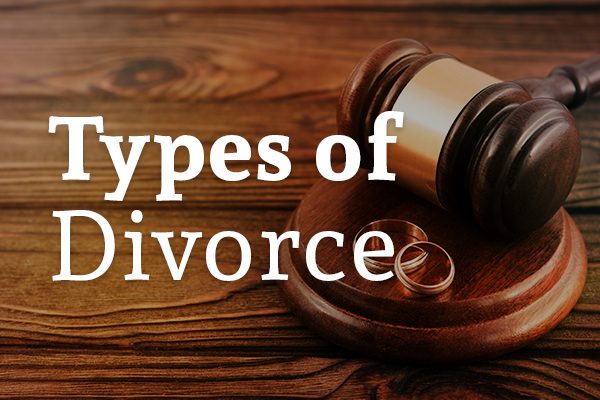 A gavel on a wooden desk with two rings and the words, types of divorce.